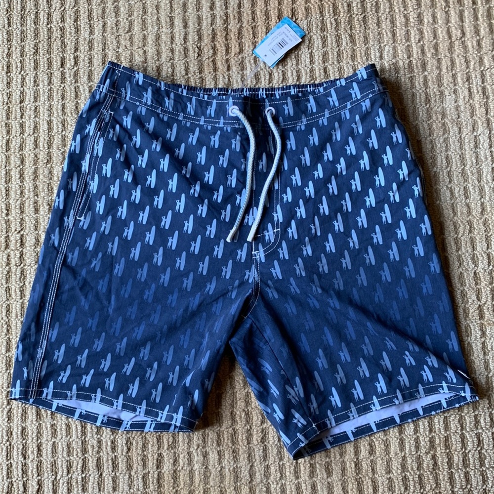 Medium sized Johnnie-O bathing suit. Blue fade with surfer print. New with tags